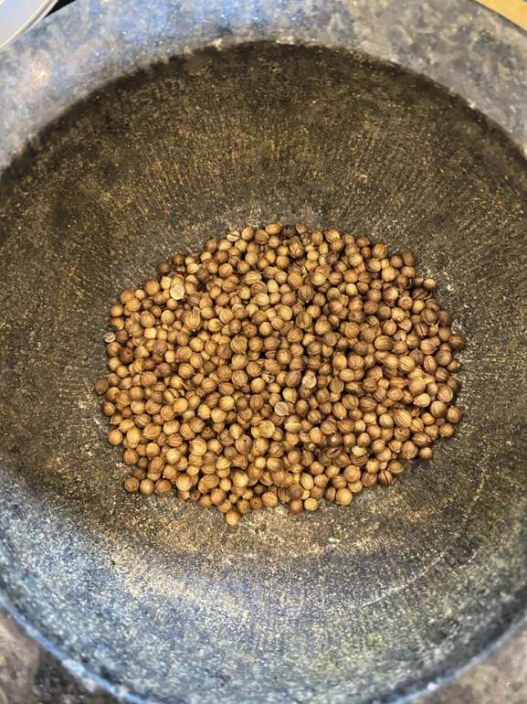 Coriander seeds in a dark mortar, photographed during Experiment 001