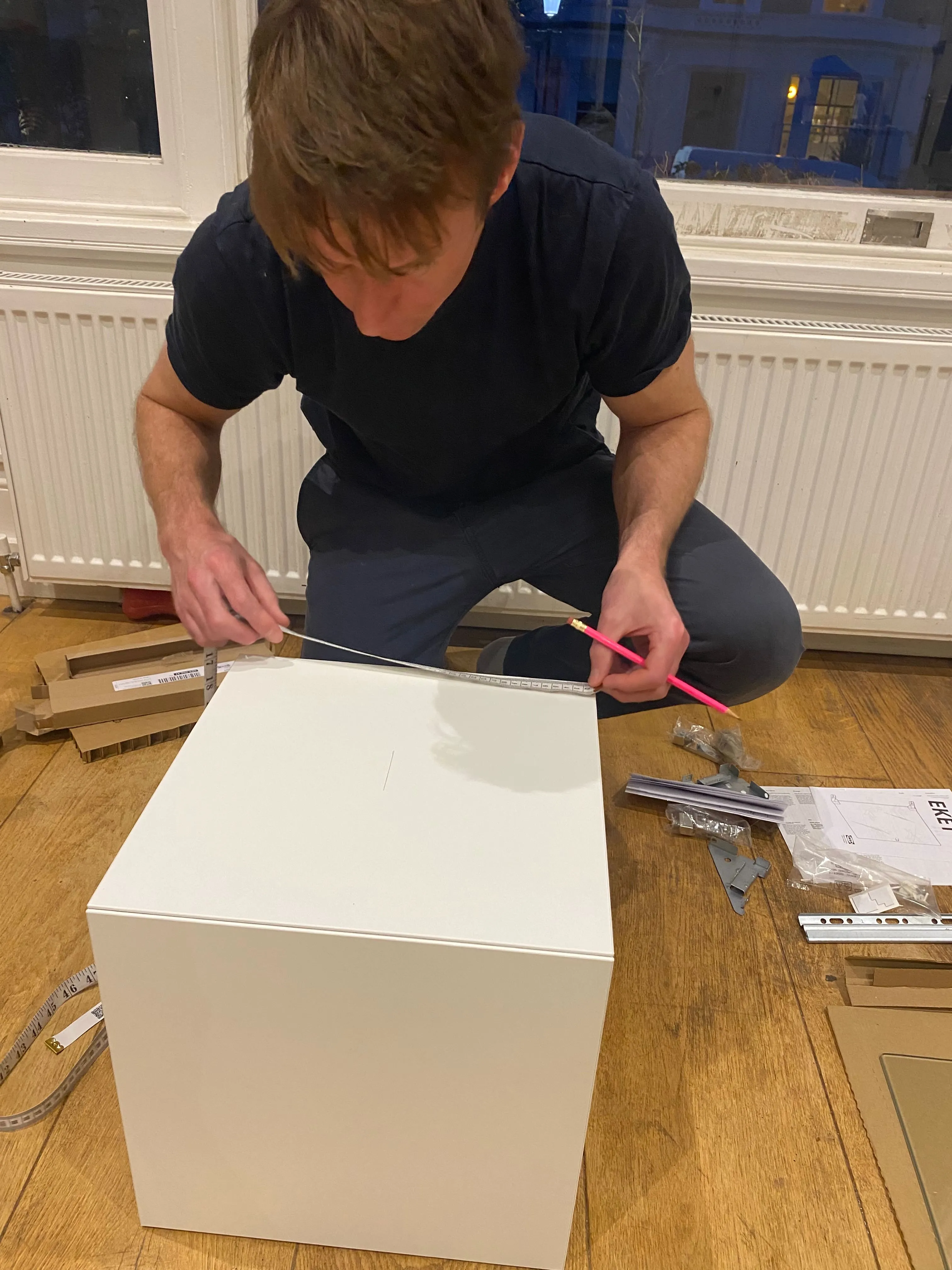 Measuring the top panel of the EKET cabinet to find the centre for the fan aperture
