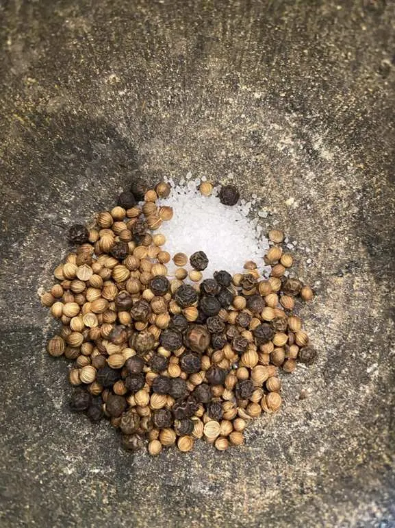 Black peppercorns before grinding